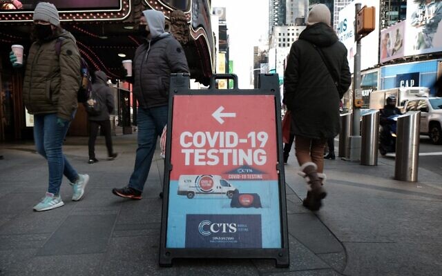 People pass COVID-19 testing site on a Manhattan street, January 21, 2022, in New York City. (Spencer Platt/Getty Images/AFP) People pass COVID-19 testing site on a Manhattan street, January 21, 2022, in New York City. (Spencer Platt/Getty Images/AFP)