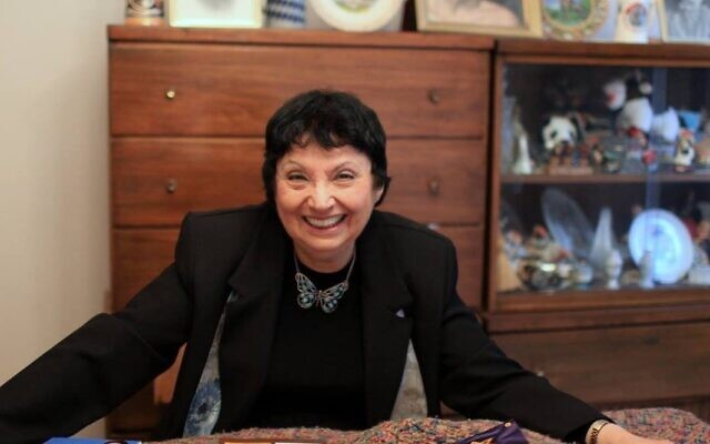 Inge Auerbacher, an 87-year-old Holocaust survivor who lives in Jamaica, Queens, poses with the books she's written. (Courtesy/ via JTA)