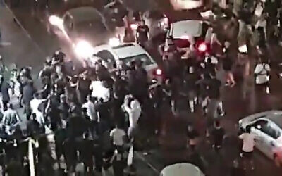 Dozens attack the vehicle of Saeed Mousa, an Arab man, in Bat Yam on May 12, 2021. (Screenshot: Twitter)