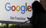 In this May 1, 2019, file photo, a person walks past a Google sign in San Francisco. (AP Photo/Jeff Chiu, File)