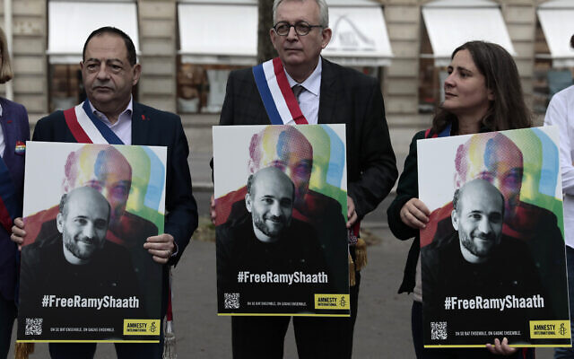 French officials hold portraits of Ramy Shaath during a rally near the Egyptian embassy in Paris, June 23, 2021. (AP Photo/ Lewis Joly) French officials hold portraits of Ramy Shaath during a rally near the Egyptian embassy in Paris, June 23, 2021. (AP Photo/ Lewis Joly)