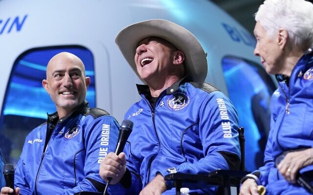 Mark Bezos, left, Jeff Bezos, center, founder of Amazon and space tourism company Blue Origin, and Wally Funk, right, make comments during a post launch news briefing from its spaceport near Van Horn, Texas, Tuesday, July 20, 2021. (AP Photo/Tony Gutierrez) Mark Bezos, left, Jeff Bezos, center, founder of Amazon and space tourism company Blue Origin, and Wally Funk, right, make comments during a post launch news briefing from its spaceport near Van Horn, Texas, Tuesday, July 20, 2021. (AP Photo/Tony Gutierrez)
