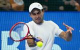 Aslan Karatsev returns a shot during the men's singles final match of the Kremlin Cup tennis tournament in Moscow, Russia, on October 24, 2021. (AP Photo/Alexander Zemlianichenko)