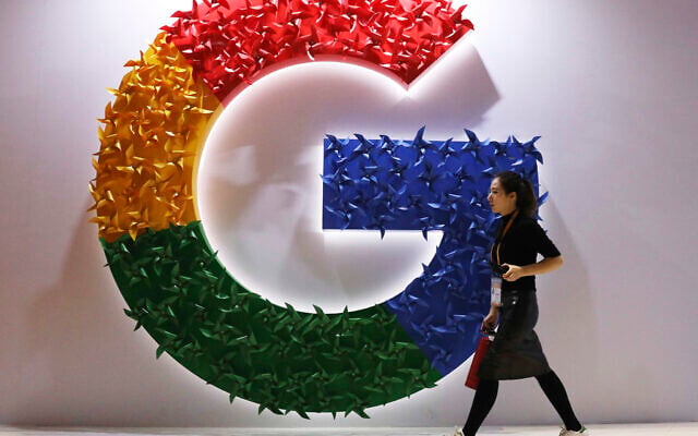 A woman walks past the logo for Google at the China International Import Expo in Shanghai, on Monday, November 5, 2018. (AP/Ng Han Guan, File)