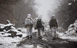 Ukrainian soldiers walk at the line of separation from pro-Russian rebels near Katerinivka, Donetsk region, Ukraine, December 7, 2021. (AP Photo/Andriy Dubchak)
