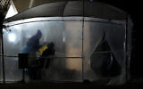 A rapid coronavirus test is taken in a temporary facility outside a pharmacy in Lakatamia a suburb of Nicosia, Cyprus, on December 13, 2021. (AP Photo/Petros Karadjias)