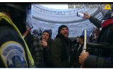 This image from Metropolitan Police Department body worm camera video and contained in the Statement of Facts supporting an arrest warrant for Pauline Bauer, pointing second to left, taken in the Rotunda of the U.S. Capitol on Jan. 6, 2021, in Washington. (Justice Department via AP)