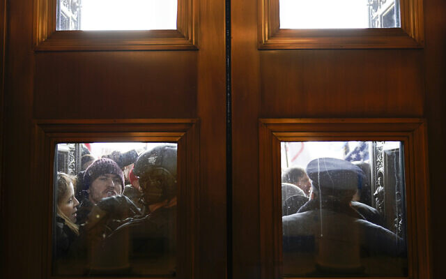 US Capitol Police try to hold back rioters outside the east doors to the House side of the US Capitol, on January 6, 2021. (Andrew Harnik/AP) US Capitol Police try to hold back rioters outside the east doors to the House side of the US Capitol, on January 6, 2021. (Andrew Harnik/AP)