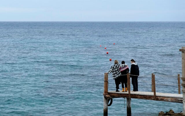 Nadine Kalache Maalouf (center), Celine Elbacha, and Elbacha's daughter Morgane (right) stand on a deck at the seaside in eastern coastal resort of Paralimni, Cyprus, on December 22, 2021. (AP Photo/Petros Karadjias) Nadine Kalache Maalouf (center), Celine Elbacha, and Elbacha's daughter Morgane (right) stand on a deck at the seaside in eastern coastal resort of Paralimni, Cyprus, on December 22, 2021. (AP Photo/Petros Karadjias)