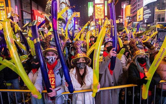 Revellers gather during the New Year's Eve celebrations in Times Square on Dec. 31, 2021, in New York. (AP Photo/Jeenah Moon) Revellers gather during the New Year's Eve celebrations in Times Square on Dec. 31, 2021, in New York. (AP Photo/Jeenah Moon)