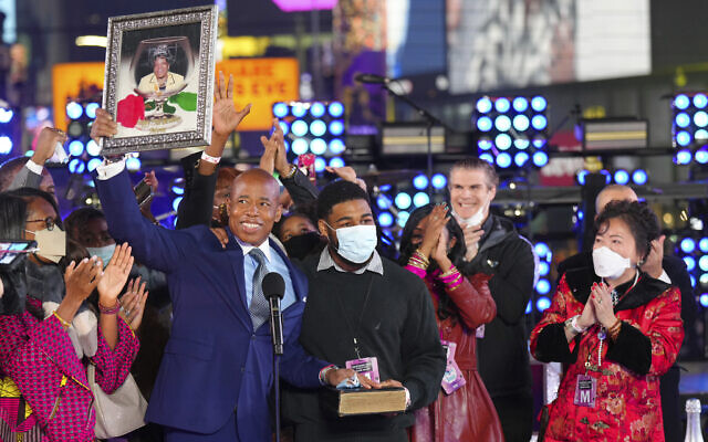 Eric Adams holds up a framed image of his mother at his swearing-in as New York mayor at the Times Square New Year's Eve celebration early Jan. 1, 2022, in New York. (Ben Hider/Invision/AP) Eric Adams holds up a framed image of his mother at his swearing-in as New York mayor at the Times Square New Year's Eve celebration early Jan. 1, 2022, in New York. (Ben Hider/Invision/AP)