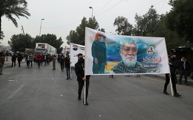 Supporters and members of the Popular Mobilization Forces hold posters of a powerful Iranian general and a top Iraqi militia leader in Baghdad, Iraq, Jan. 1, 2022. (Khalid Mohammed/AP) Supporters and members of the Popular Mobilization Forces hold posters of a powerful Iranian general and a top Iraqi militia leader in Baghdad, Iraq, Jan. 1, 2022. (Khalid Mohammed/AP)