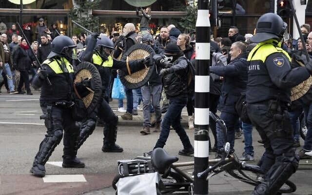 Police clash with demonstrators as thousands of people defied a ban to gather and protest the Dutch government's coronavirus lockdown measures, in Amsterdam, Netherlands, January 2, 2022. (AP Photo/Peter Dejong) Police clash with demonstrators as thousands of people defied a ban to gather and protest the Dutch government's coronavirus lockdown measures, in Amsterdam, Netherlands, January 2, 2022. (AP Photo/Peter Dejong)
