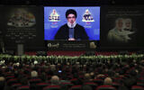 Hezbollah leader Hassan Nasrallah speaks via a video link in the southern Beirut suburb of Dahiyeh, Lebanon, January 3, 2022. (AP Photo/Bilal Hussein)