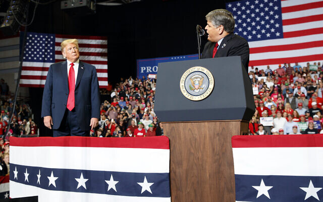 President Donald Trump listens Fox News' Sean Hannity speak during a rally on Nov. 5, 2018, in Cape Girardeau, Mo. (AP Photo/Carolyn Kaster, File) President Donald Trump listens Fox News' Sean Hannity speak during a rally on Nov. 5, 2018, in Cape Girardeau, Mo. (AP Photo/Carolyn Kaster, File)
