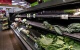Nearly empty shelves of produce at a supermarket in Washington, Tuesday, Jan. 4, 2022. (AP Photo/Andrew Harnik)