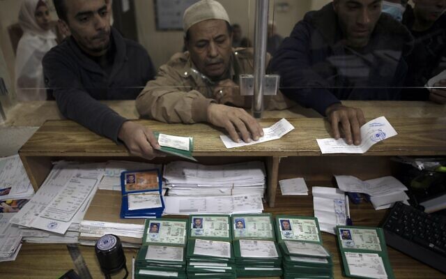 Palestinians wait to receive their national IDs at the civil affairs office in Gaza City, January 5, 2022. (AP Photo/ Khalil Hamra) Palestinians wait to receive their national IDs at the civil affairs office in Gaza City, January 5, 2022. (AP Photo/ Khalil Hamra)