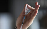 Illustrative: A medical student prepares a syringe with vaccination against COVID-19 in Berlin, Germany, January 5, 2022. (AP Photo/Markus Schreiber)