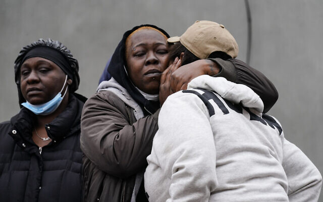 People gather near the scene of a deadly row house fire, Jan. 5, 2022, in the Fairmount neighborhood of Philadelphia. (AP Photo/Matt Rourke)