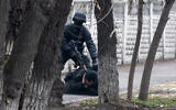 An armed riot police officer detains a protester during a security anti-terrorists operation in a street after clashes in Almaty, Kazakhstan, Jan. 8, 2022 (AP Photo/Vasily Krestyaninov)