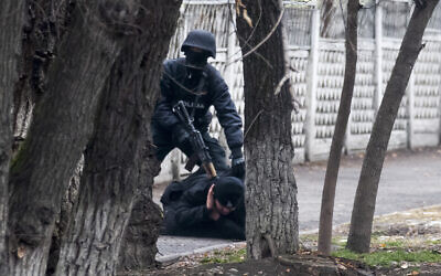 An armed riot police officer detains a protester during a security anti-terrorists operation in a street after clashes in Almaty, Kazakhstan, Jan. 8, 2022 (AP Photo/Vasily Krestyaninov)