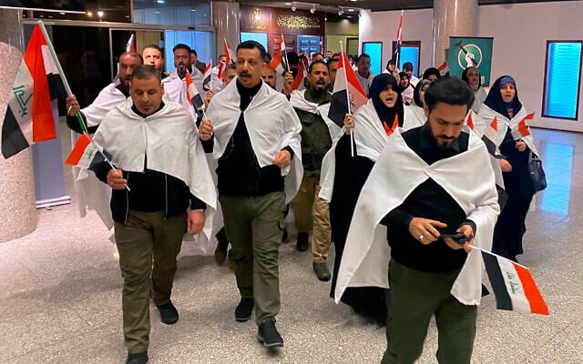 Newly elected lawmakers from the Sadr political bloc ​prepare to attend the first parliament session, in Baghdad, Iraq, Sunday, Jan. 9, 2022. (AP Photo/Ali Abdul Hassan)