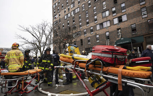 Firefighters work outside an apartment building after a fire in the Bronx, January 9, 2022, in New York. (AP Photo/Yuki Iwamura) Firefighters work outside an apartment building after a fire in the Bronx, January 9, 2022, in New York. (AP Photo/Yuki Iwamura)