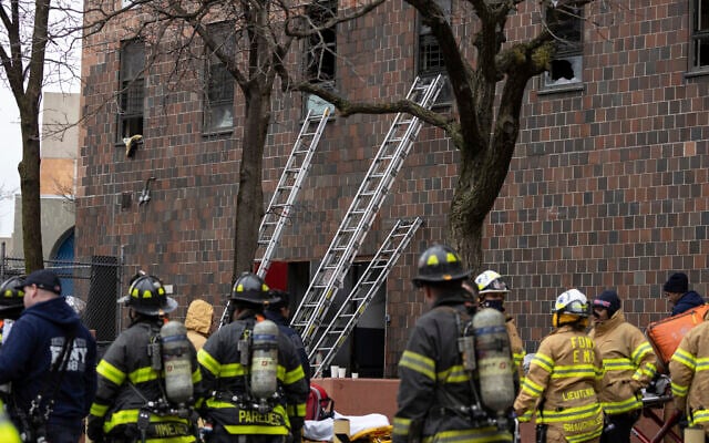Ladders are seen erected beside the apartment building where a fire occurred in the Bronx on January 9, 2022, in New York. (AP Photo/Yuki Iwamura) Ladders are seen erected beside the apartment building where a fire occurred in the Bronx on January 9, 2022, in New York. (AP Photo/Yuki Iwamura)
