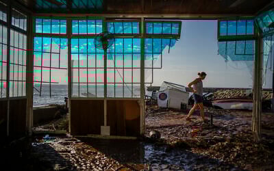 Carla Bayerri inspects her restaurant after flooding in the seaside town of Alcanar, in northeastern Spain, September 2, 2021. (Joan Mateu Parra/AP)