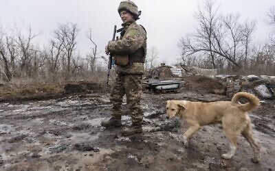 A Ukrainian soldier walks on the line of separation from pro-Russian rebels, Donetsk region, Ukraine, on Monday, January 10, 2022. (AP Photo/Andriy Dubchak)