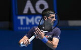 Defending men's champion Serbia's Novak Djokovic practices at the Rod Laver Arena ahead of the Australian Open tennis championship in Melbourne, Australia, January 12, 2022. (Mark Baker/AP)