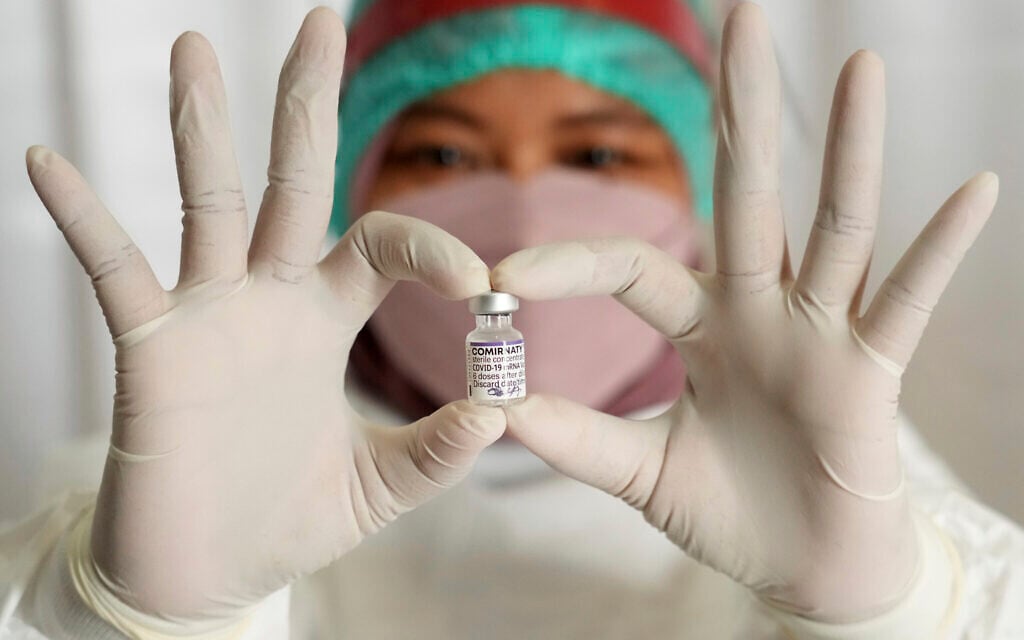 As part of the global race to vaccinate against COVID-19, a medical worker at South Tangerang Regional General Hospital in Tangerang, Indonesia, holds a vaccine vial the she is using to administer third doses on, Jan. 12, 2022. (AP Photo/Tatan Syuflana) As part of the global race to vaccinate against COVID-19, a medical worker at South Tangerang Regional General Hospital in Tangerang, Indonesia, holds a vaccine vial the she is using to administer third doses on, Jan. 12, 2022. (AP Photo/Tatan Syuflana)