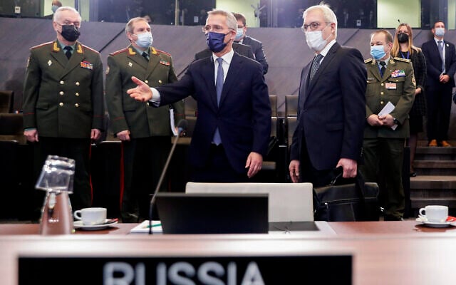 NATO Secretary General Jens Stoltenberg, center, and Russia's Deputy Foreign Minister Alexander Grushko, fourth right, arrive for the NATO-Russia Council at NATO headquarters, in Brussels, January 12, 2022. (Olivier Hoslet, Pool Photo via AP)
