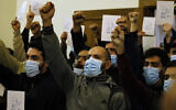 Supporters of the Iranian-backed Hezbollah group chant slogans as they hold posters of Sheikh Nimr al-Nimr, a prominent opposition Saudi Shiite cleric who was executed by Saudi Arabia in 2016, during a conference for Saudi opposition in the southern Beirut suburb of Dahiyeh, Lebanon, Wednesday, Jan. 12, 2022. (AP Photo/Bilal Hussein)