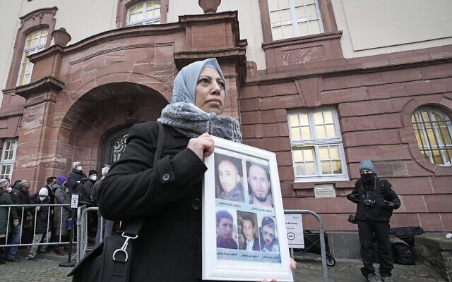 Syrian woman Yasmen Almashan holds the pictures of her five brothers killed in Syria before the verdict in front of the court in Koblenz, Germany, Thursday, Jan. 13, 2022. (AP Photo/Martin Meissner) Syrian woman Yasmen Almashan holds the pictures of her five brothers killed in Syria before the verdict in front of the court in Koblenz, Germany, Thursday, Jan. 13, 2022. (AP Photo/Martin Meissner)