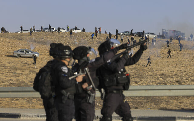 Israeli security forces fire tear gas at Bedouin demonstrators following a protest against a forestation project by the Jewish National Fund near the Bedouin village of Sa'we al-Atrash in the Negev Desert, southern Israel, January 13, 2022. (AP Photo/Tsafrir Abayov) Israeli security forces fire tear gas at Bedouin demonstrators following a protest against a forestation project by the Jewish National Fund near the Bedouin village of Sa'we al-Atrash in the Negev Desert, southern Israel, January 13, 2022. (AP Photo/Tsafrir Abayov)
