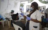 A man takes a rapid COVID-19 test in Doula, during an African Cup of Nations 2022 soccer match between Cameroon and Ethiopia at the Olembe stadium in Yaounde, Cameroon, Thursday, Jan. 13, 2022. (AP Photo/Sunday Alamba)