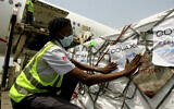 A shipment of COVID-19 vaccines distributed by the COVAX Facility arrives in Abidjan, Ivory Coast, Febuary 25, 2021. (AP Photo/Diomande Ble Blonde)