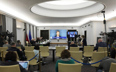 A Polish Senate commission heard the testimony of two cybersecurity experts, John Scott-Railton and Bill Marczak, senior researchers with the Citizen Lab, a research group based at the University of Toronto, in Warsaw, Poland, on Monday, January 17, 2022. (AP/Czarek Sokolowski)