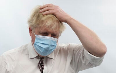 Britain's Prime Minister Boris Johnson gestures during a visit to Finchley Memorial Hospital, in North London, January 18, 2022. (Ian Vogler, Pool Photo via AP)