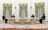Russian President Vladimir Putin (left) and Iranian President Ebrahim Raisi talk to each other during their meeting in the Kremlin in Moscow, Russia, on Wednesday, January 19, 2022. (Pavel Bednyakov/Sputnik, Kremlin Pool Photo via AP)