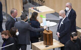 Lawmakers vote on compulsory COVID-19 vaccination in the parliament in Vienna, Austria, on January 20, 2022. (AP Photo/Lisa Leutner)