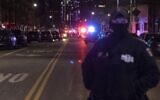 An NYPD officer stands at the scene of shooting in Harlem on January 21, 2022, in New York. (AP Photo/Yuki Iwamura)