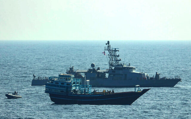 US service members board a stateless fishing vessel transiting international waters in the Gulf of Oman as a rigid-hull inflatable boat and patrol coastal ship USS Chinook (PC 9) sail nearby, Jan. 18, 2022. (US Navy via AP) US service members board a stateless fishing vessel transiting international waters in the Gulf of Oman as a rigid-hull inflatable boat and patrol coastal ship USS Chinook (PC 9) sail nearby, Jan. 18, 2022. (US Navy via AP)