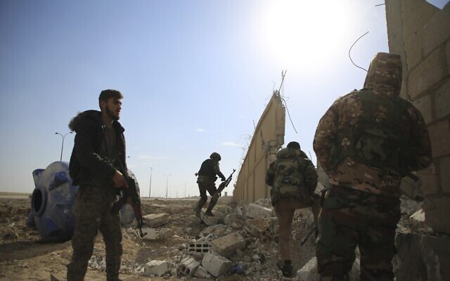 Kurdish-led Syrian Democratic Forces fighters take their positions at the defense wall of Gweiran Prison in Hassakeh, northeast Syria, Sunday, Jan. 23, 2022 (AP Photo/Hogir Al Abdo) Kurdish-led Syrian Democratic Forces fighters take their positions at the defense wall of Gweiran Prison in Hassakeh, northeast Syria, Sunday, Jan. 23, 2022 (AP Photo/Hogir Al Abdo)