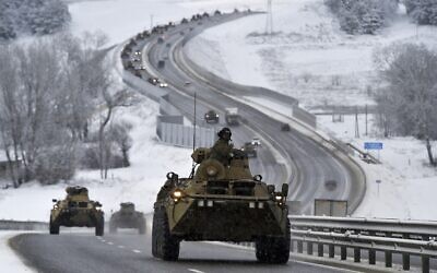 A convoy of Russian armored vehicles moves along a highway in Crimea, Jan. 18, 2022. (AP Photo)
