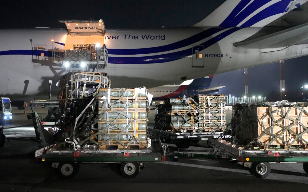 Workers unload a shipment of military aid delivered as part of the United States' security assistance to Ukraine, at the Boryspil airport, outside Kyiv, Ukraine, January 25, 2022. (AP Photo/Efrem Lukatsky)
