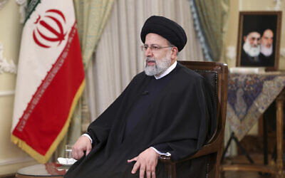 In this photo released by the official website of the office of the Iranian Presidency, President Ebrahim Raisi speaks in a live televised interview with state-run TV, in Tehran, Iran, on Tuesday, January 25, 2022. (Iranian Presidency Office via AP)