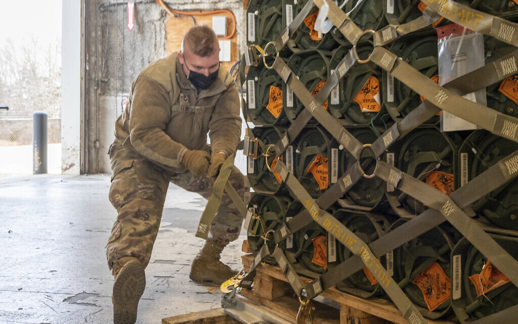 Senior Airman Zachary Kline, 436th Aerial Port Squadron cargo processor, palletizes ammunition, weapons and other equipment bound for Ukraine during a foreign military sales mission at Dover Air Force Base, Delaware, on January 21, 2022. (Mauricio Campino/US Air Force via AP)