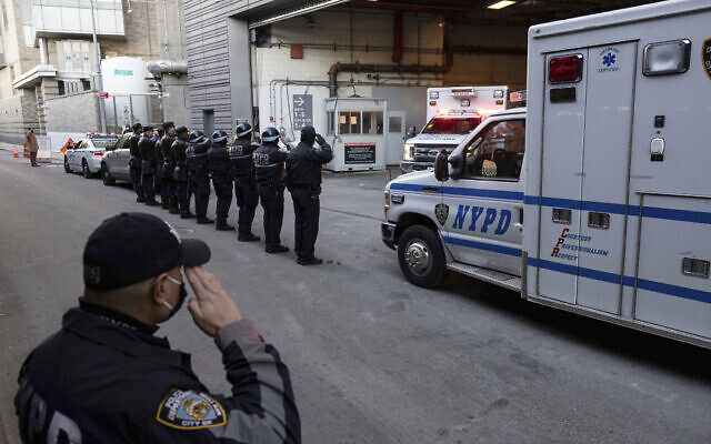 New York Police Department officers salute during the transfer of the remains of officer Wilbert Mora outside the NYU Langone hospital in New York, Tuesday, Jan. 25, 2022. (AP/Yuki Iwamura) New York Police Department officers salute during the transfer of the remains of officer Wilbert Mora outside the NYU Langone hospital in New York, Tuesday, Jan. 25, 2022. (AP/Yuki Iwamura)